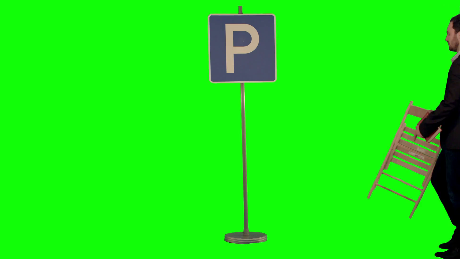Businessman reading a book near parking sign on a green screen stock