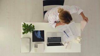 Doctor explains patient's condition by smart phone and computer with cardiogram in hands