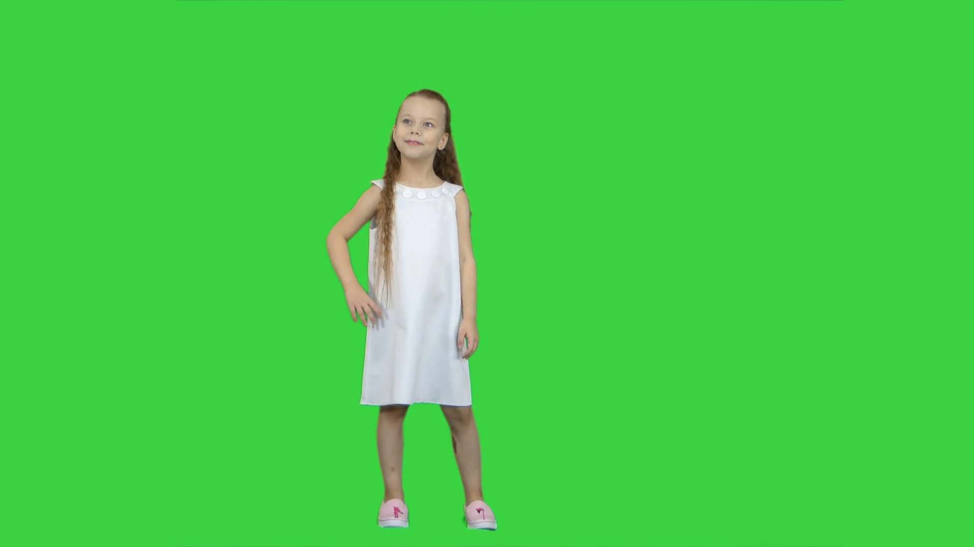 Adorable little girl smiling at camera and posing on a Green Screen