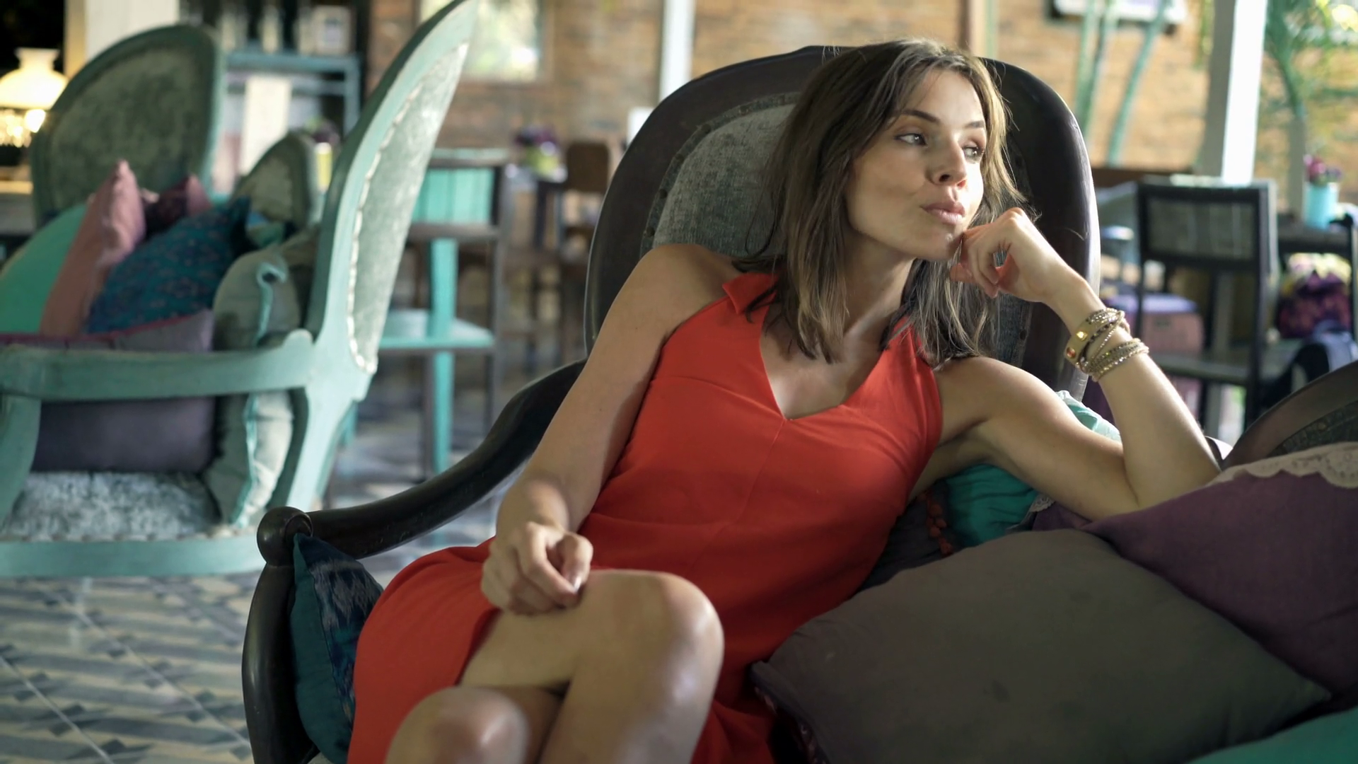 Beautiful sad woman sitting on sofa in trendy cafe. 4K Stock Video