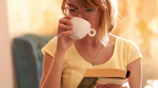 Person reading book in cafe, 4K