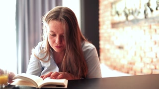 Young woman reading book at home