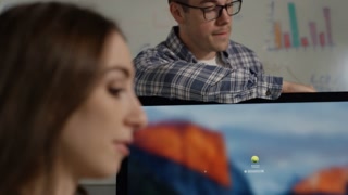 Office Workers Male And Female Working Together On A Project With Technology