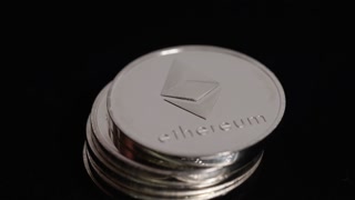 Ethereum picking up coins on black background