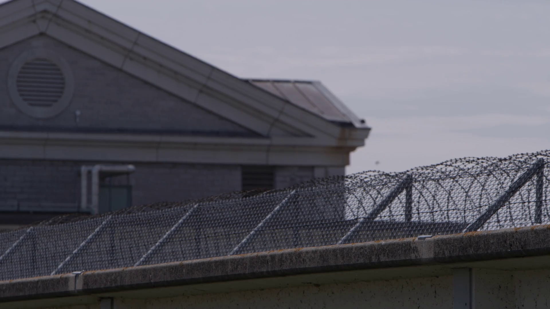 Prison Exterior Pan Across Secure Prison Stock Footage SBV347719503