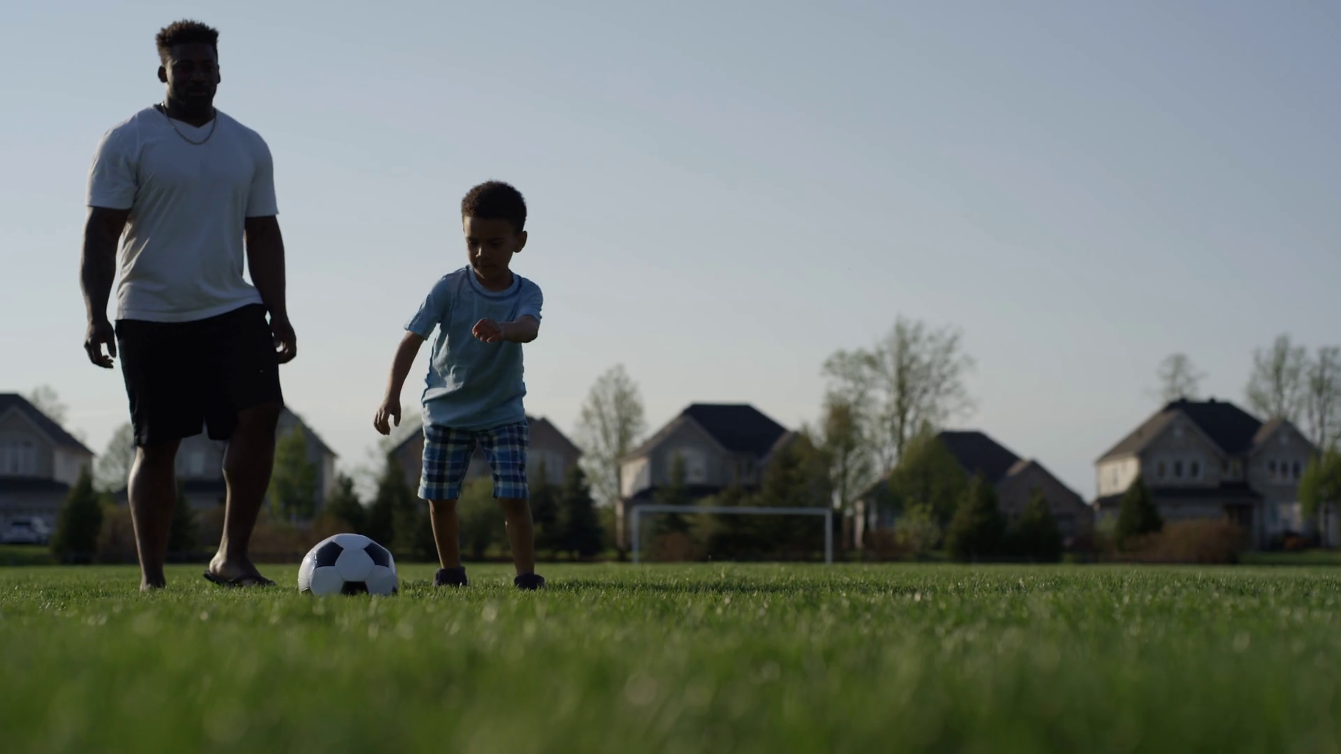 Family Fun Young Boy Kicks Soccer Ball In Stock Footage SBV347719364