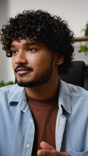 Hindu male teacher talks with students via video conference