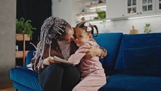 Happy Mother's Day: Young girl greets mom with a card, touching moment