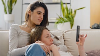Women discuss information together on phone