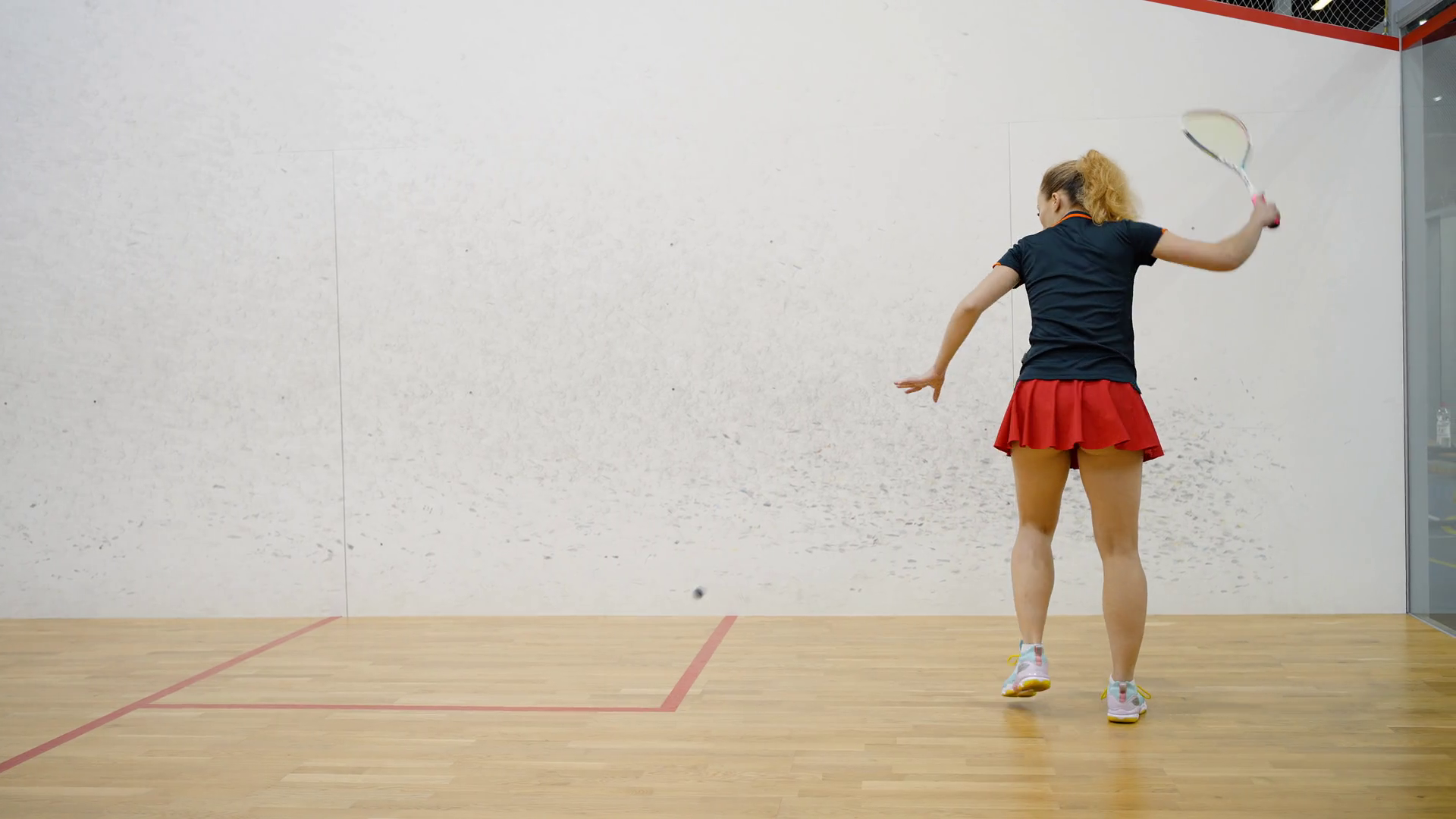 Female Squash Player Hits Ball With Racket Stock Footage SBV347358201