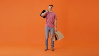 Guy throwing bags over shoulder and enjoying shopping indoor