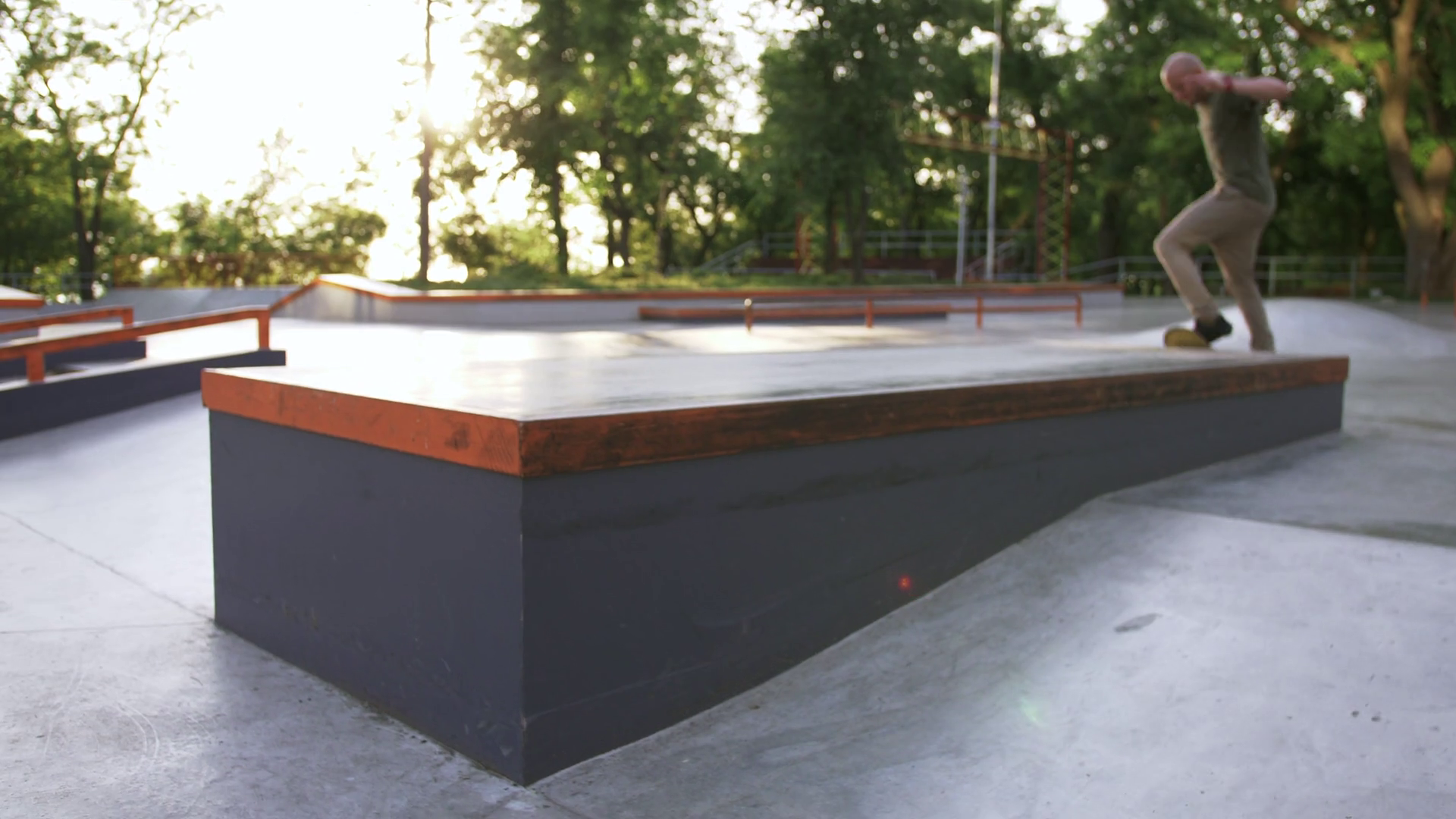 Skateboarder doing a tricks in a concrete skate park, close up, slow