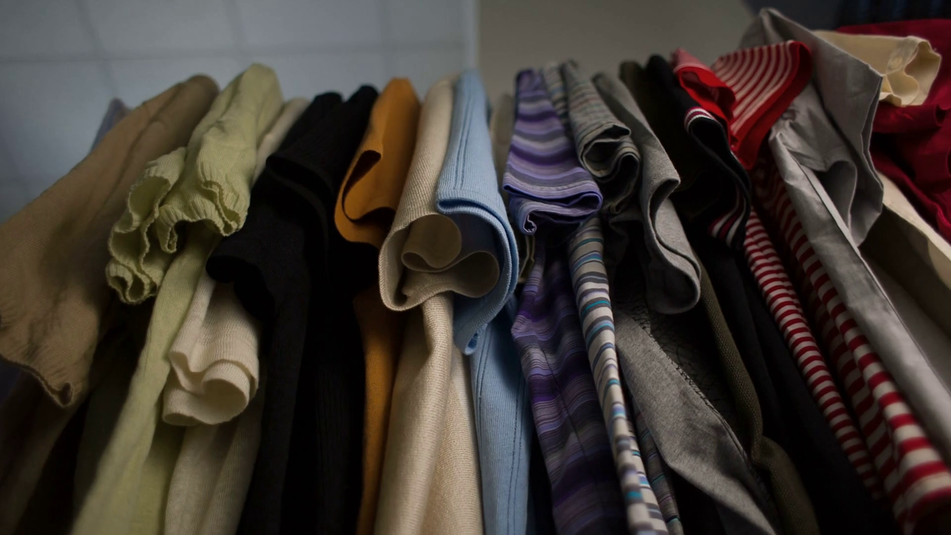 Men's Tshirts on hangers at wardrobe Stock Video Footage Storyblocks