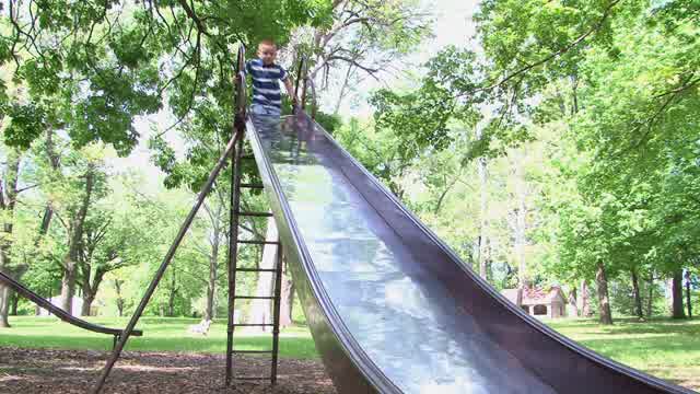 Kids Playing Playground Slide Stock Footage: Royalty-Free Video Clips ...