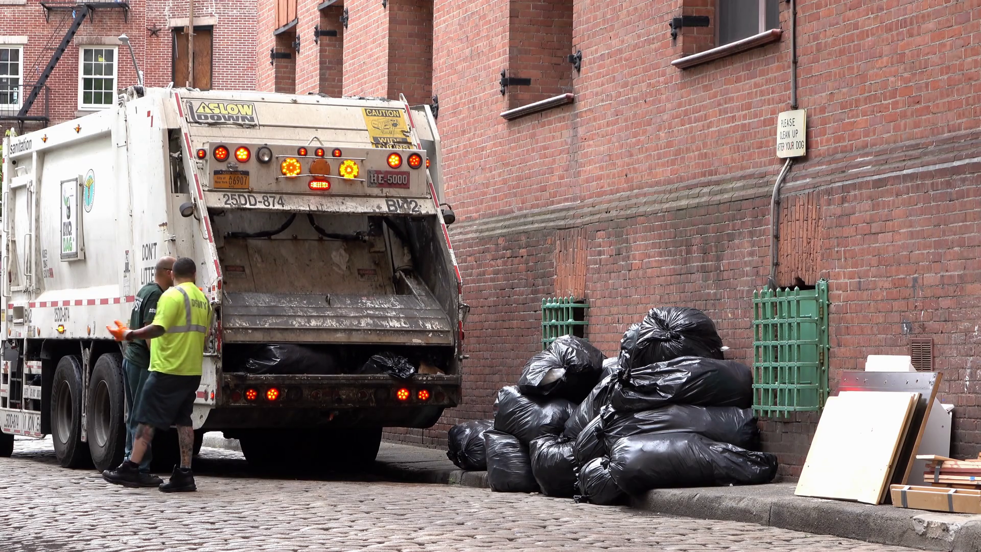 Garbage truck compacting trash bags in New York City 4k Stock Video