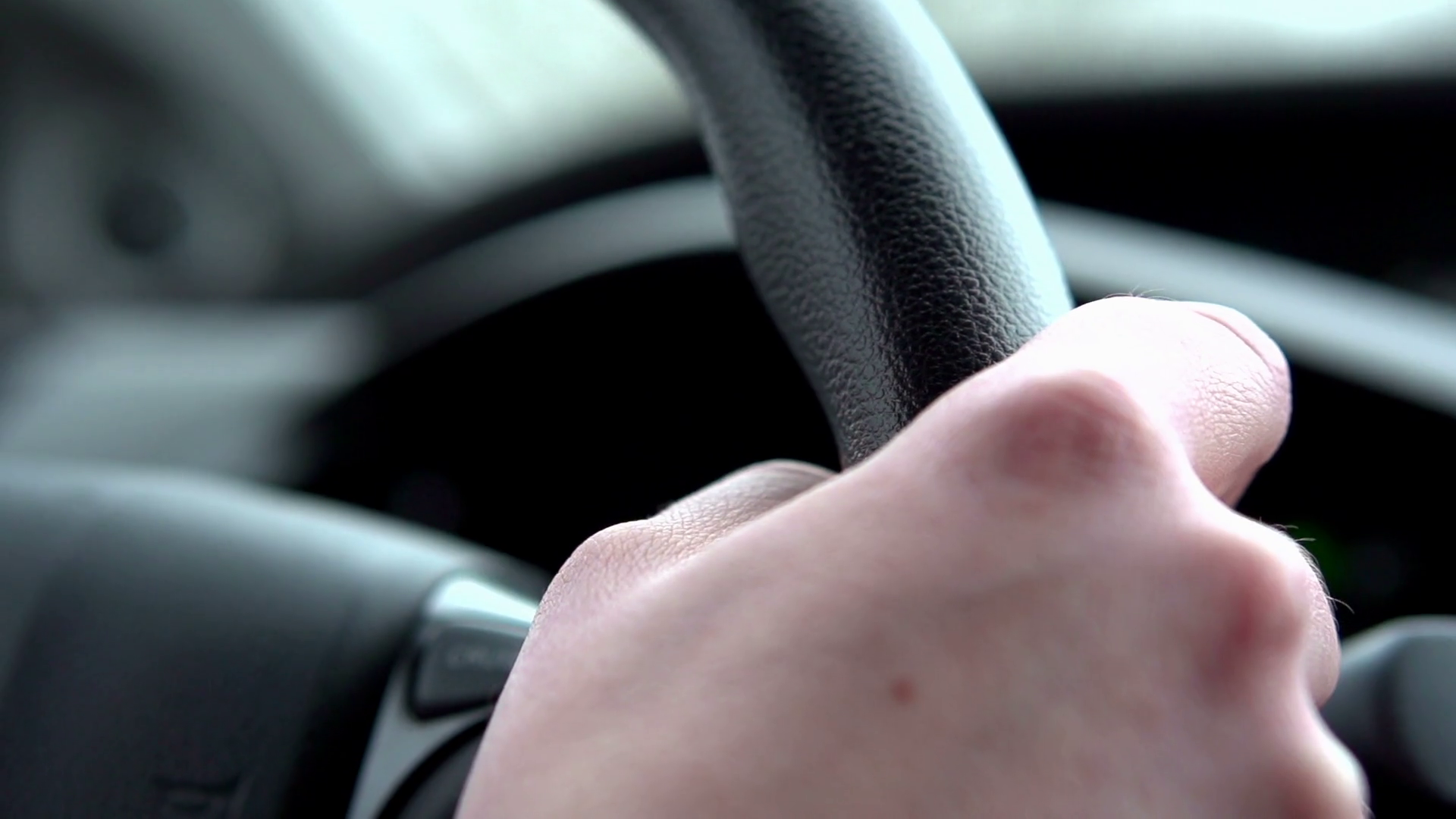 Hand of driver gripping steering wheel slow motion Stock Video Footage