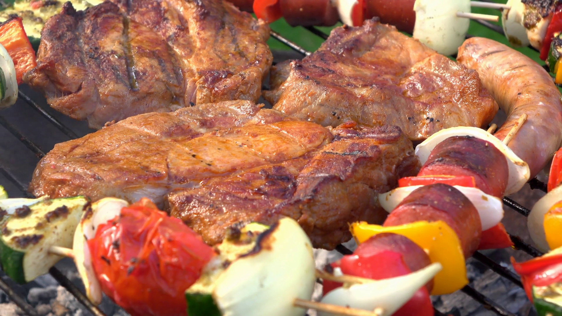 Meat cooking on fire pit grill close up 4k Stock Video Footage 0017