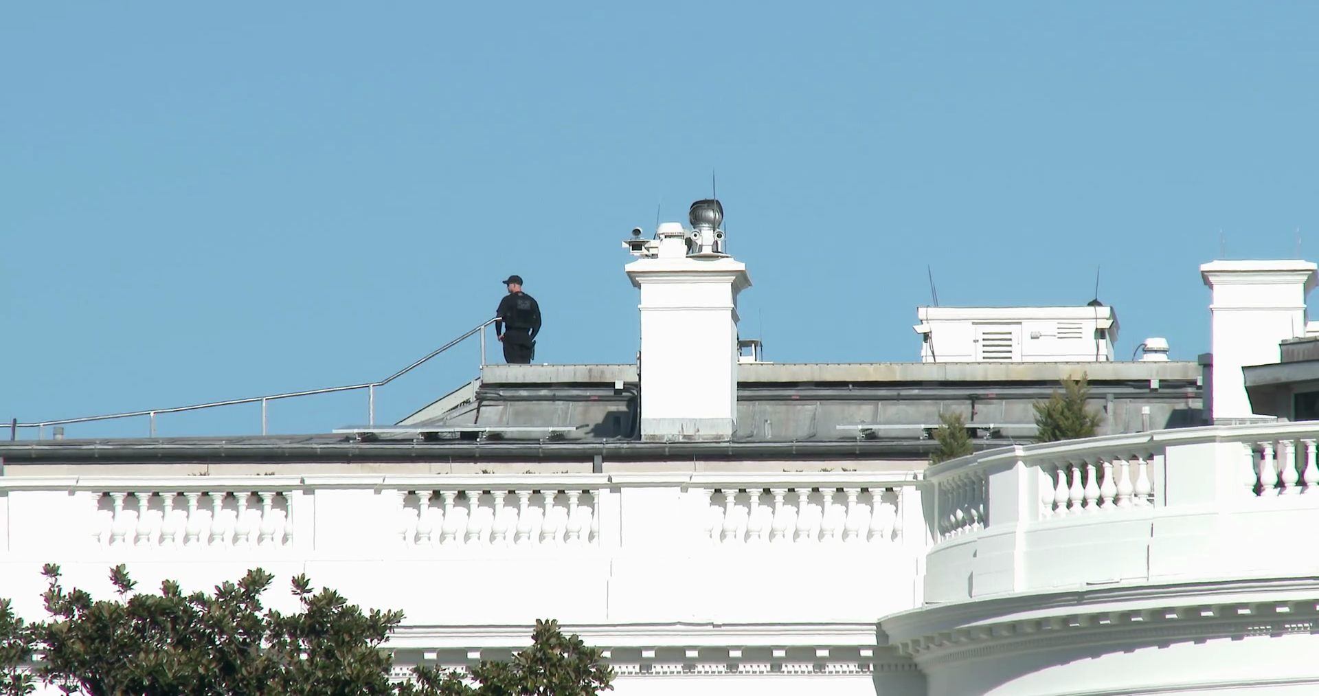 Security guard standing on roof of White House 4k Stock Video Footage