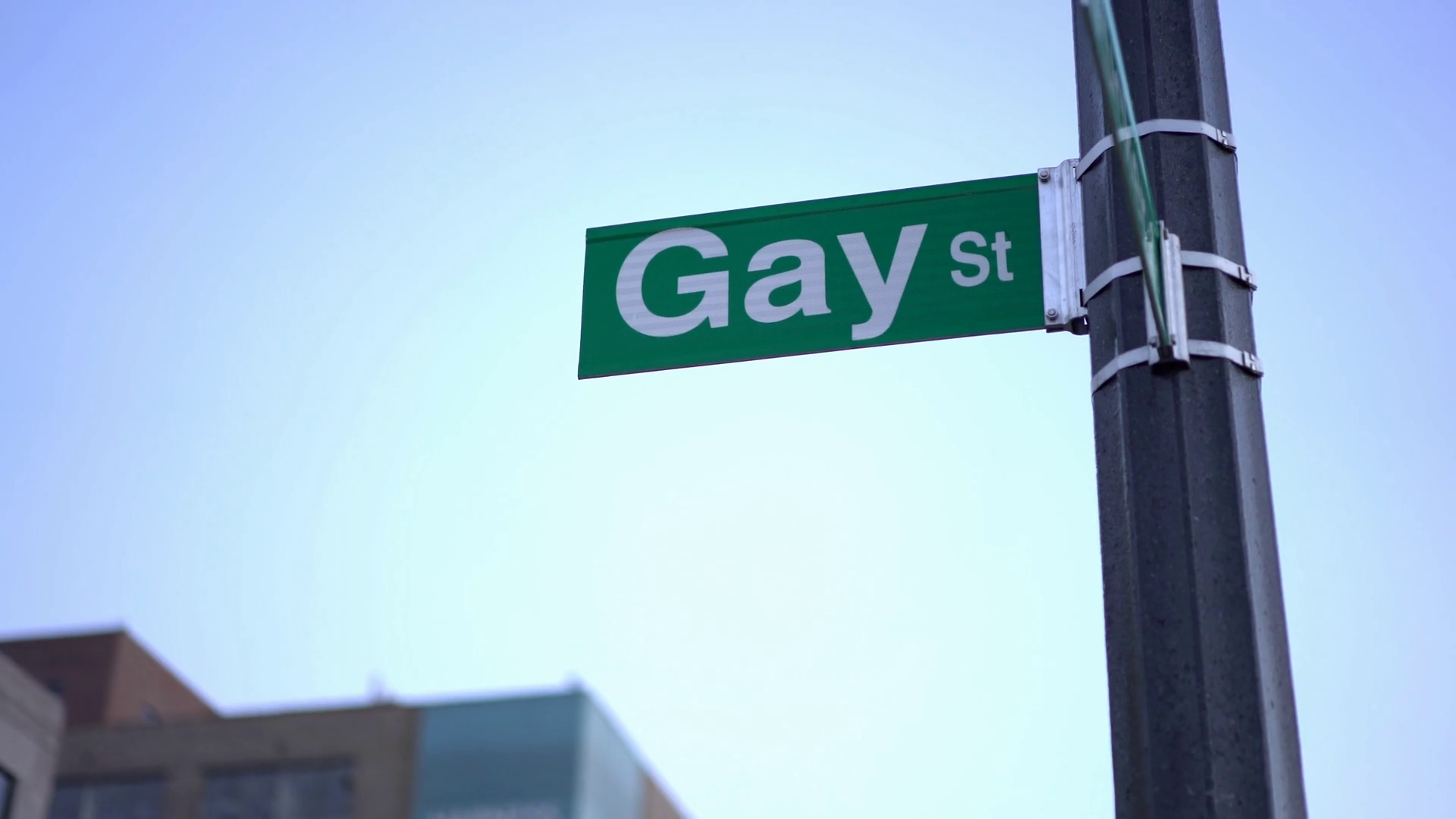 Gay street sign in downtown city evening hours 4k Stock Video Footage
