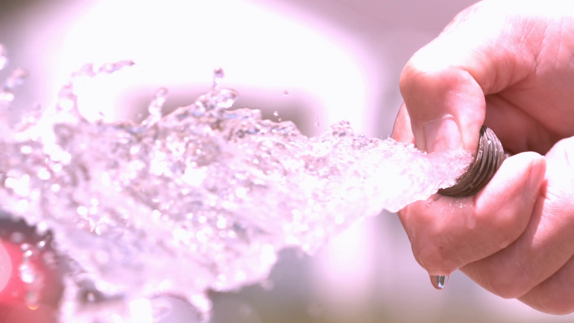 Spraying water from garden hose close up slow motion Stock Video