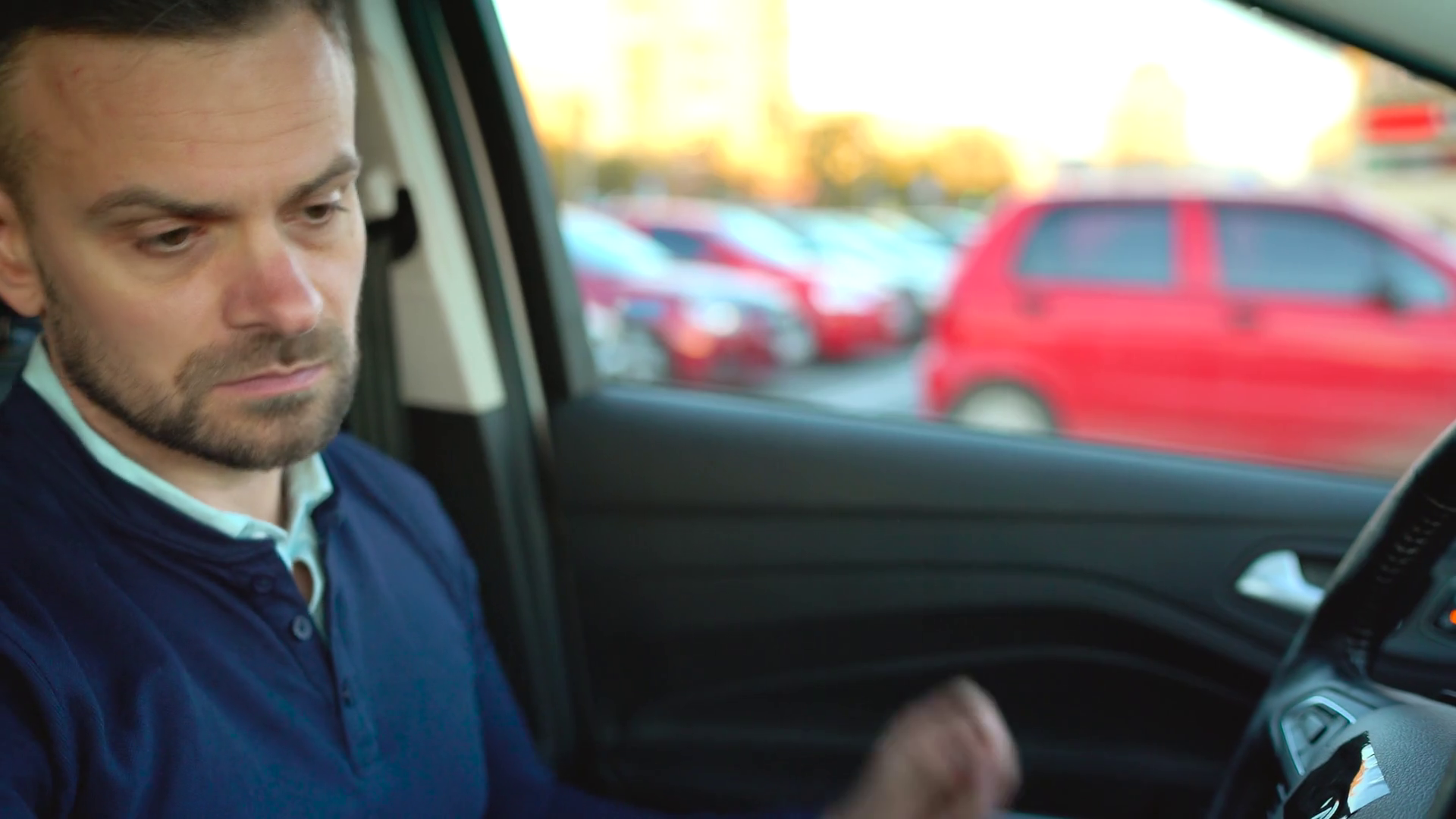Man driving a car, leaving the parking lot near the mall Stock Video