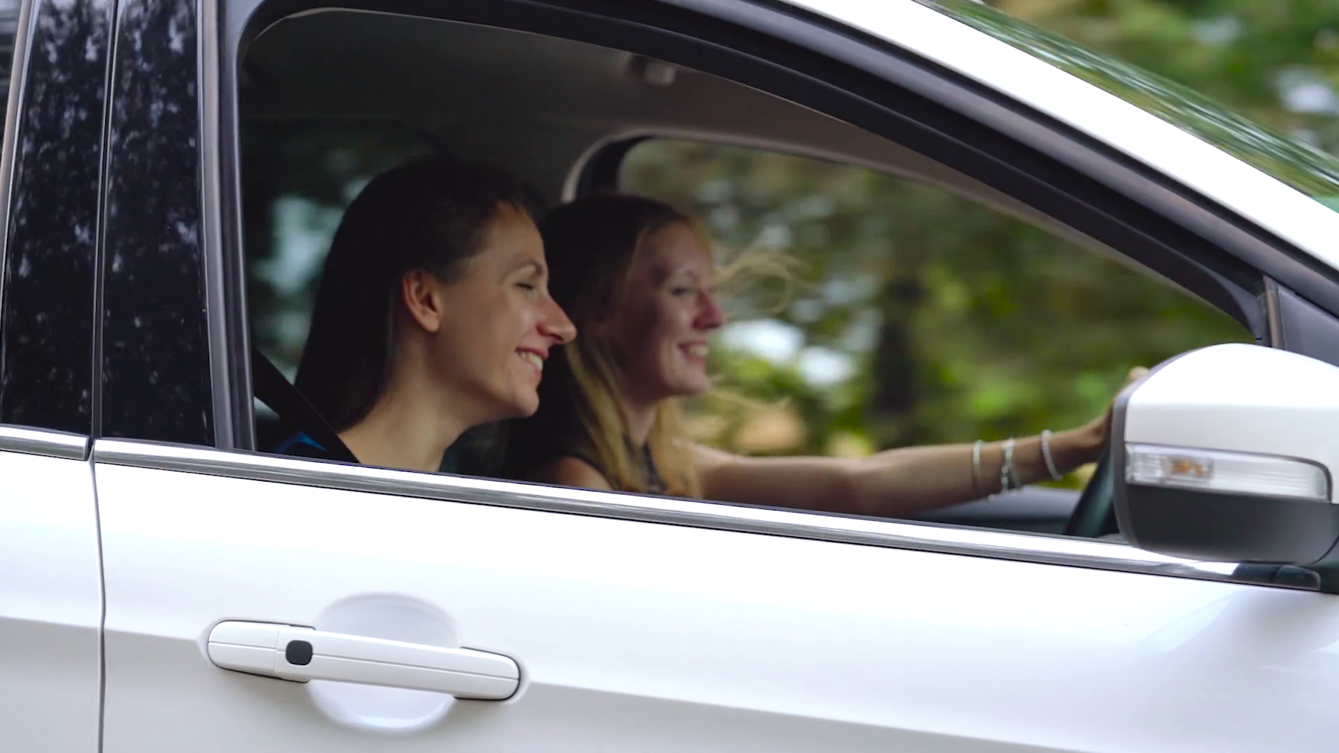 Two Young Women Ride In Car Have Fun Stock Footage SBV327749519