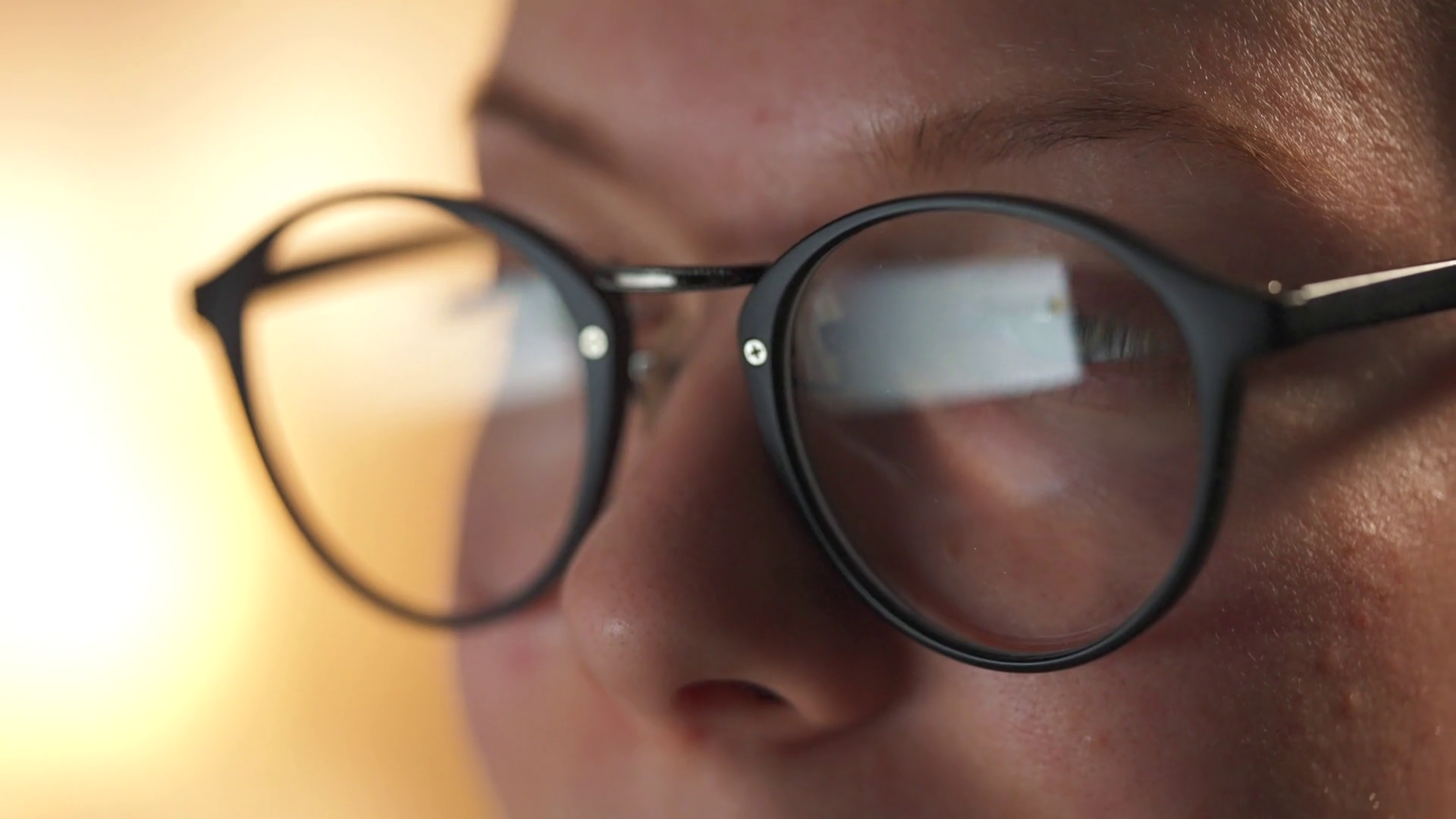 Woman in glasses looking on the monitor and surfing The