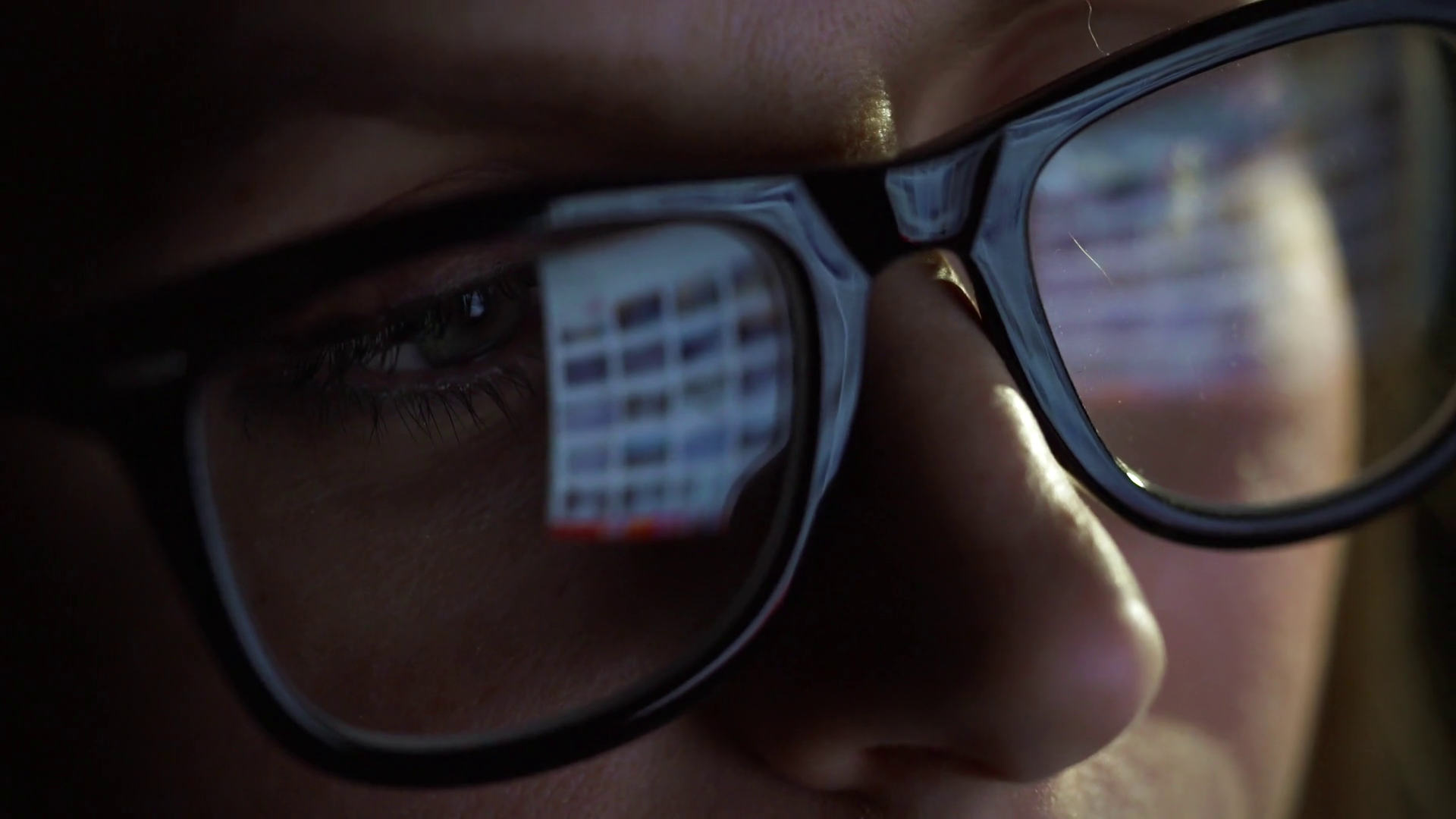 Woman in glasses looking on the monitor and surfing The