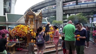 THAILAND, BANGKOK, APRIL 11, 2014: Thai people near mini buddhist temple in Bangkok downtown, Thailand