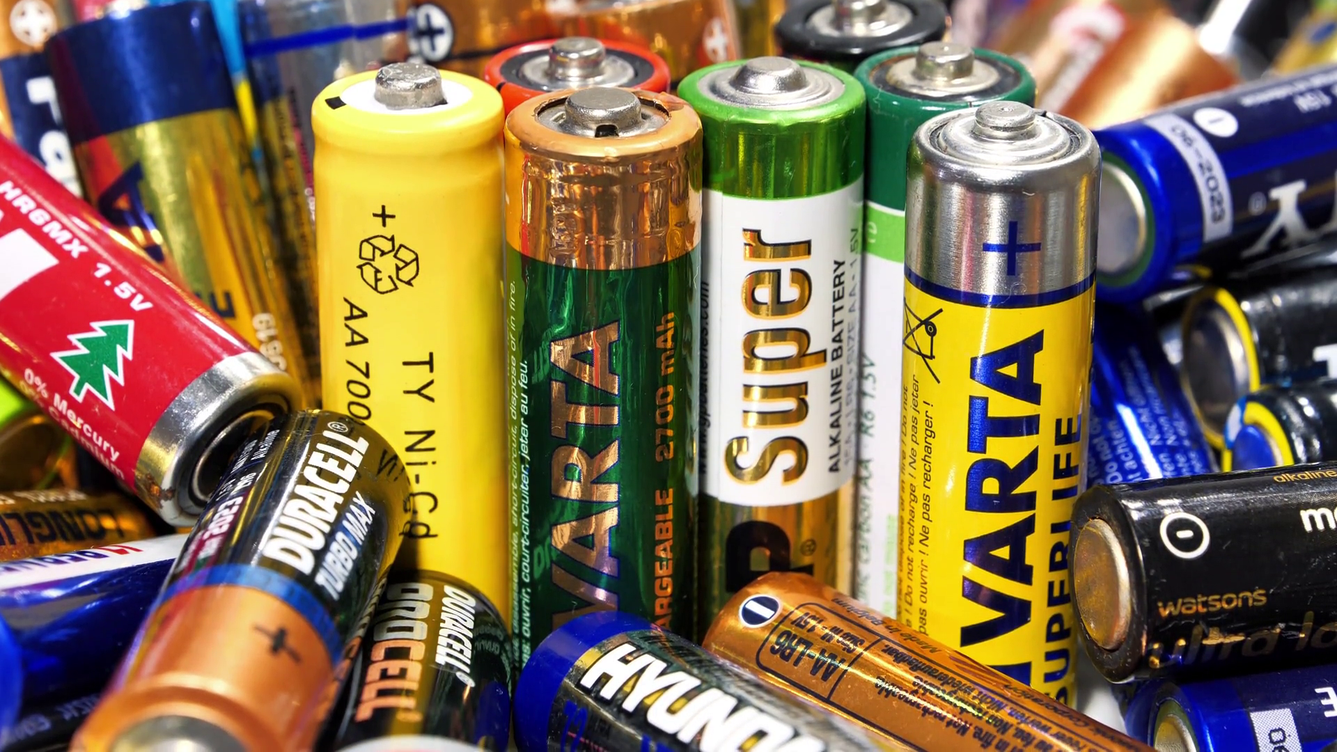 Many multicolored used batteries AA types from various manufacturers