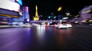 Motion time lapse footage of traffic on the Las Vegas strip at night, as viewed from the front of a vehicle moving forward