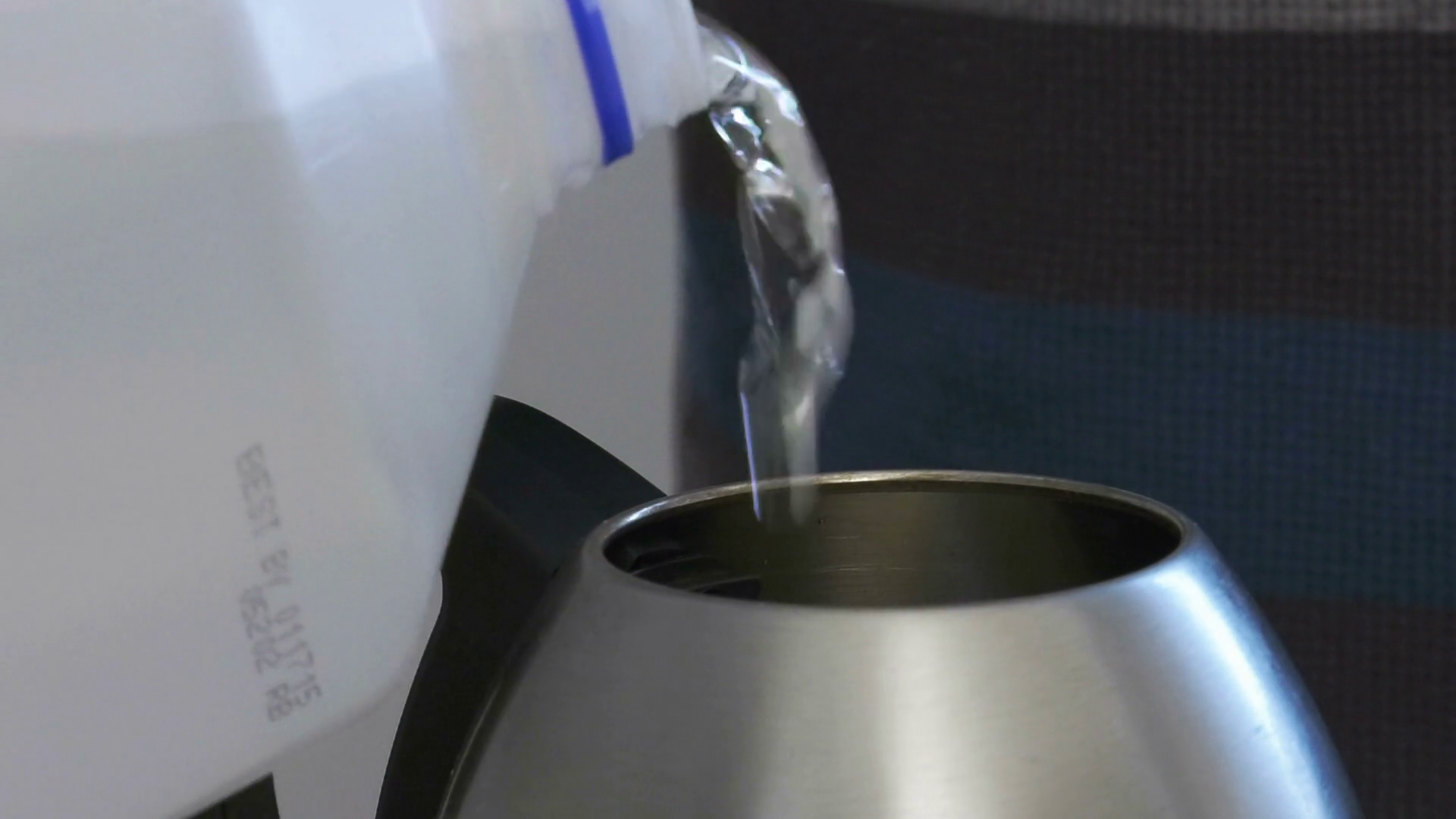 Pouring water into a stainless steel kettle Stock Video Footage Storyblocks
