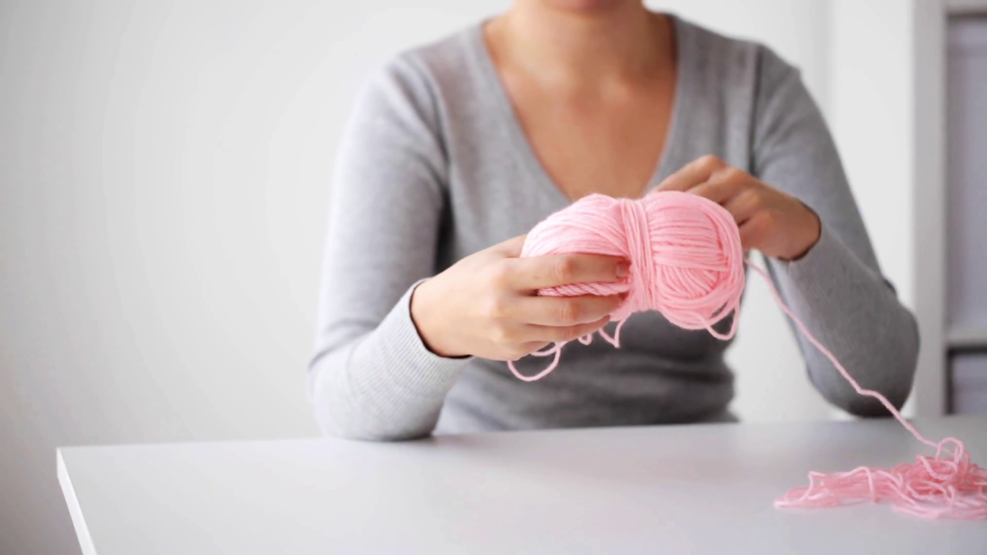 knitting, people and needlework concept woman pulling yarn up into ball Stock Video Footage 00