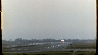 Aircraft gracefully landing on sunlit runway, 8 mm film