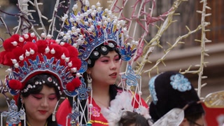 VALENCIA, SPAIN JANUARY 25, 2025: Two women wearing elaborate traditional chinese opera costumes participate in the Lunar New Year parade in