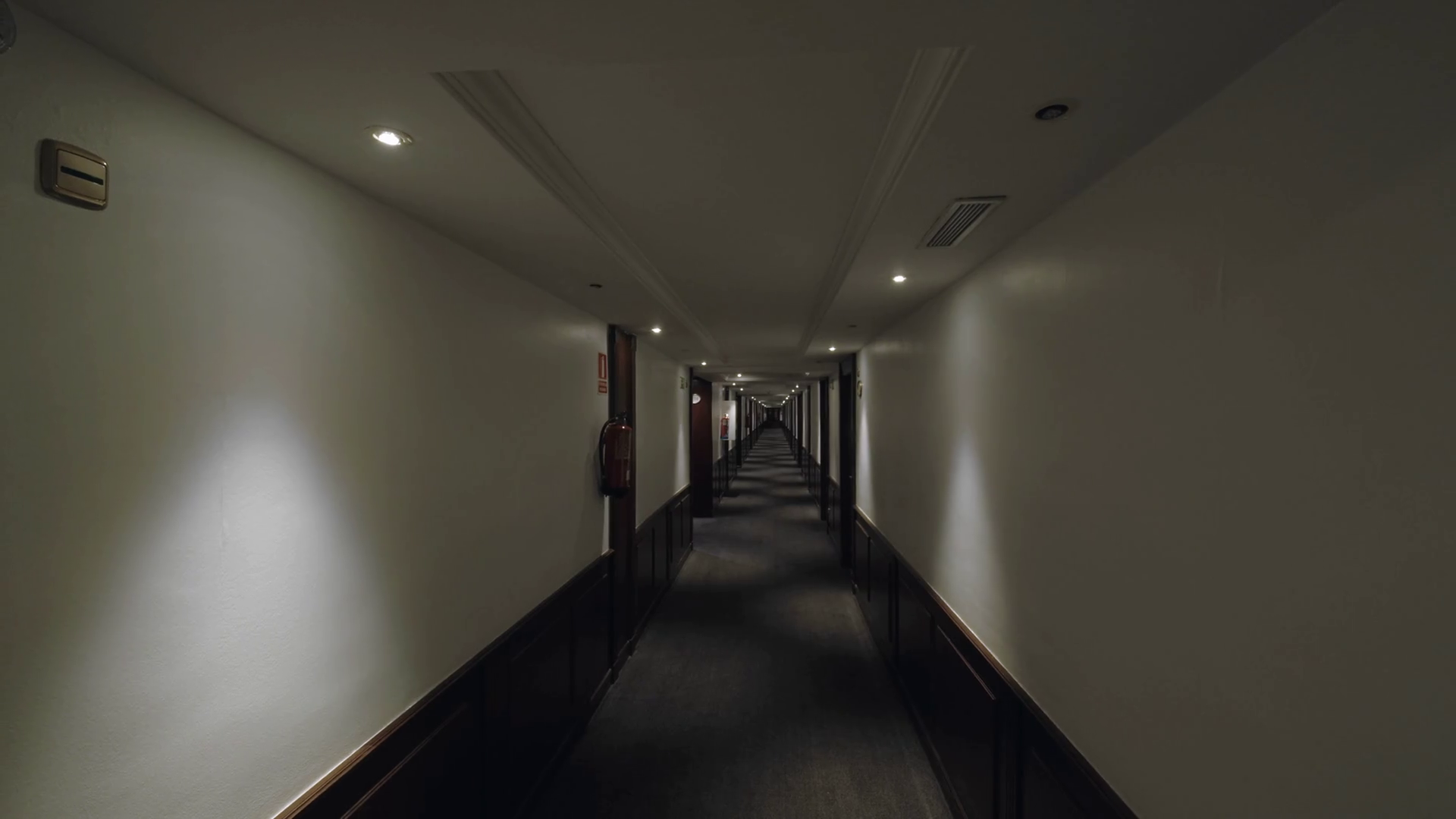Perspective shot of empty hotel hallway with following view of the room