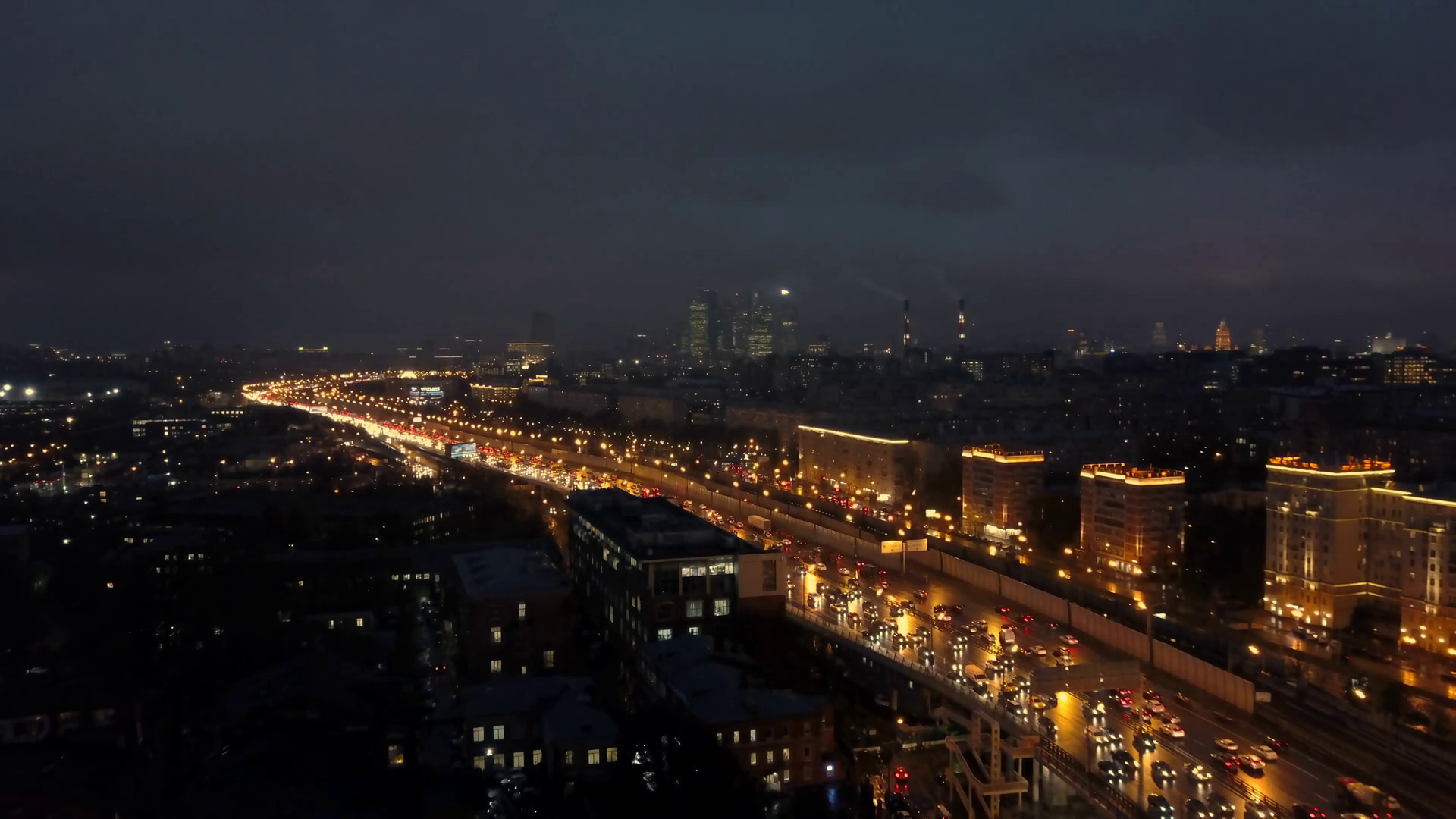 A Beautiful Aerial View Of A Night City With A Busy Highway Illuminated By Streetlights And Headlights Of Moving Cars The Sky Is Dark And The City Is Sparkling With Different Kinds