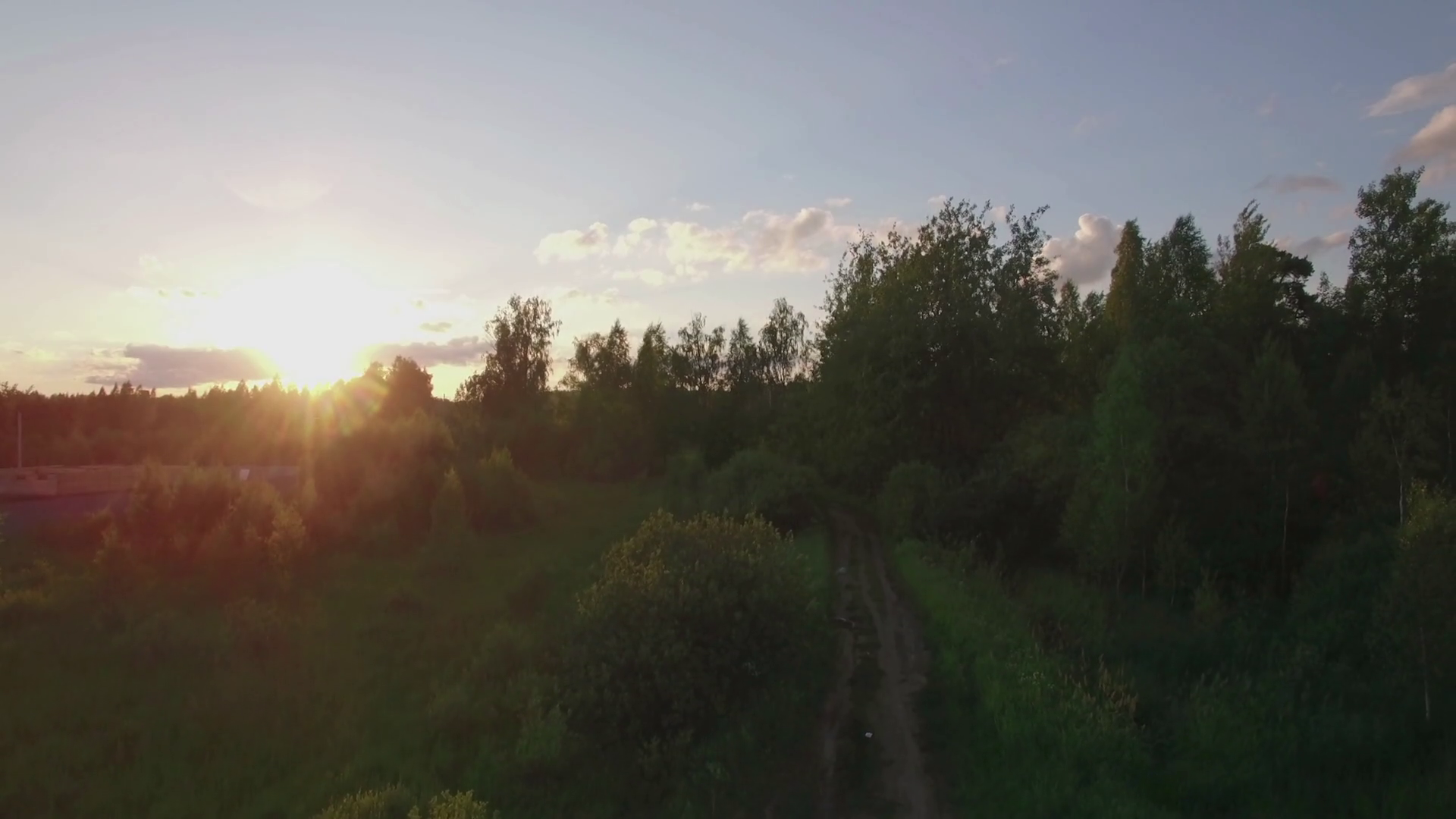 Aerial shot of village and railway at sunset. Dacha community in Russia ...
