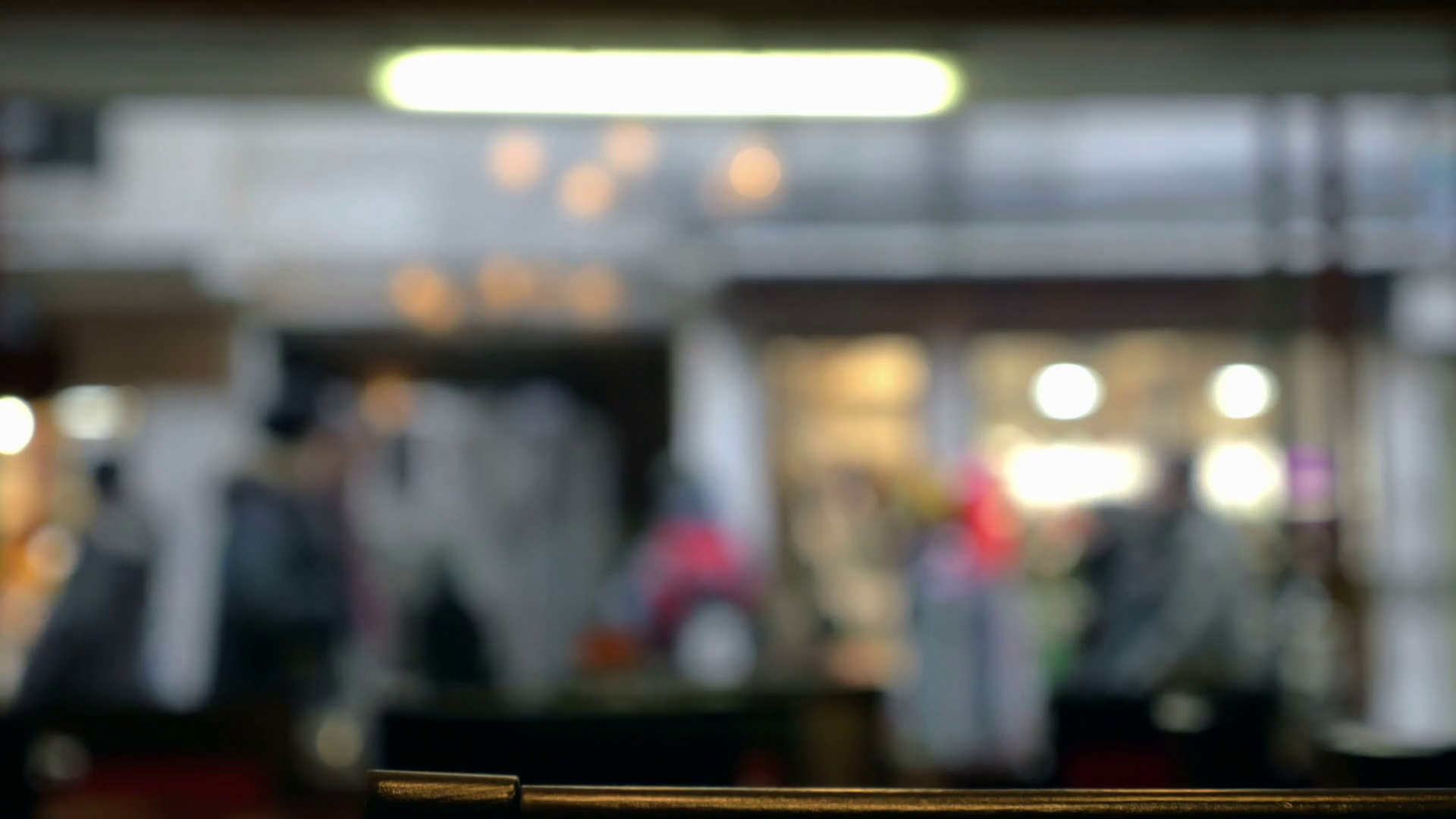 Defocused shot of people walking along the street, view ...