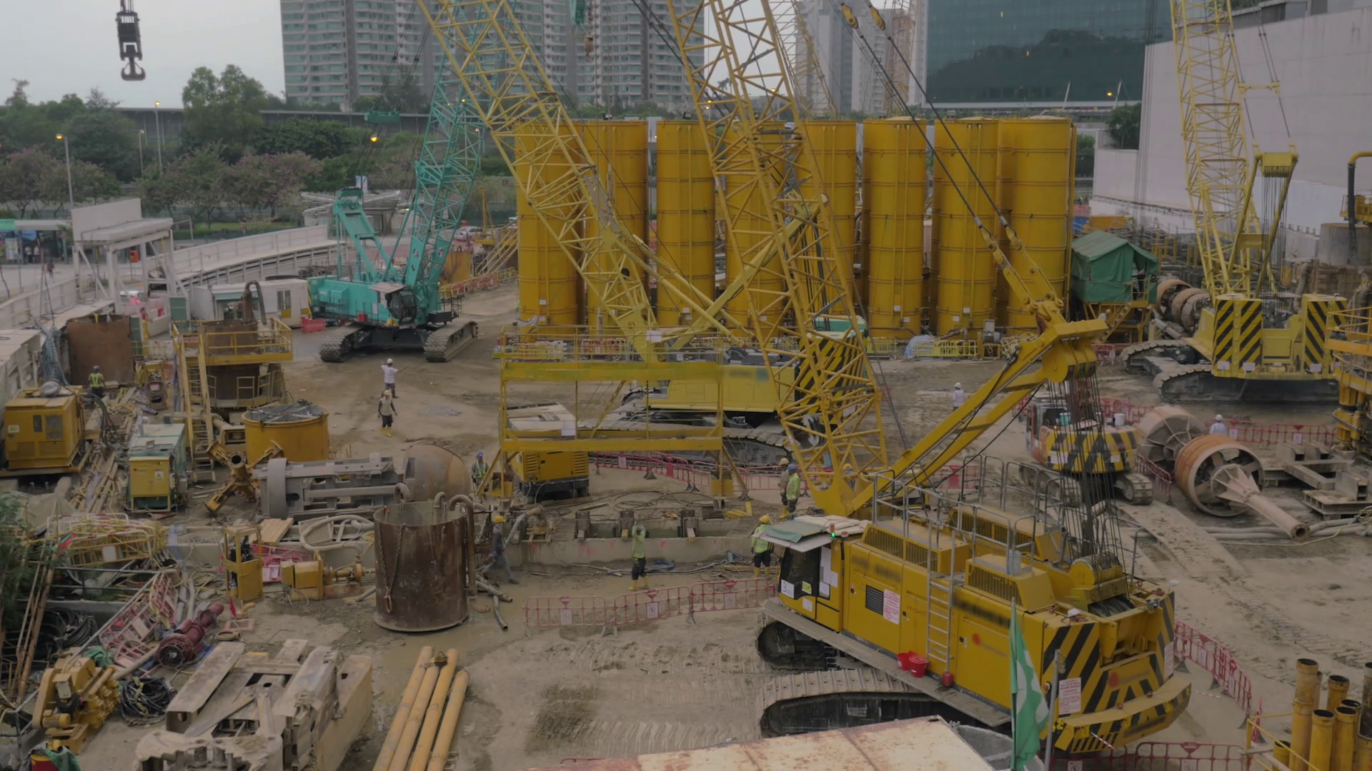 Machinery and builders working on construction site in Hong Kong Stock