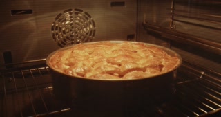 Traditional Dutch apple pie baked in oven. Time lapse.