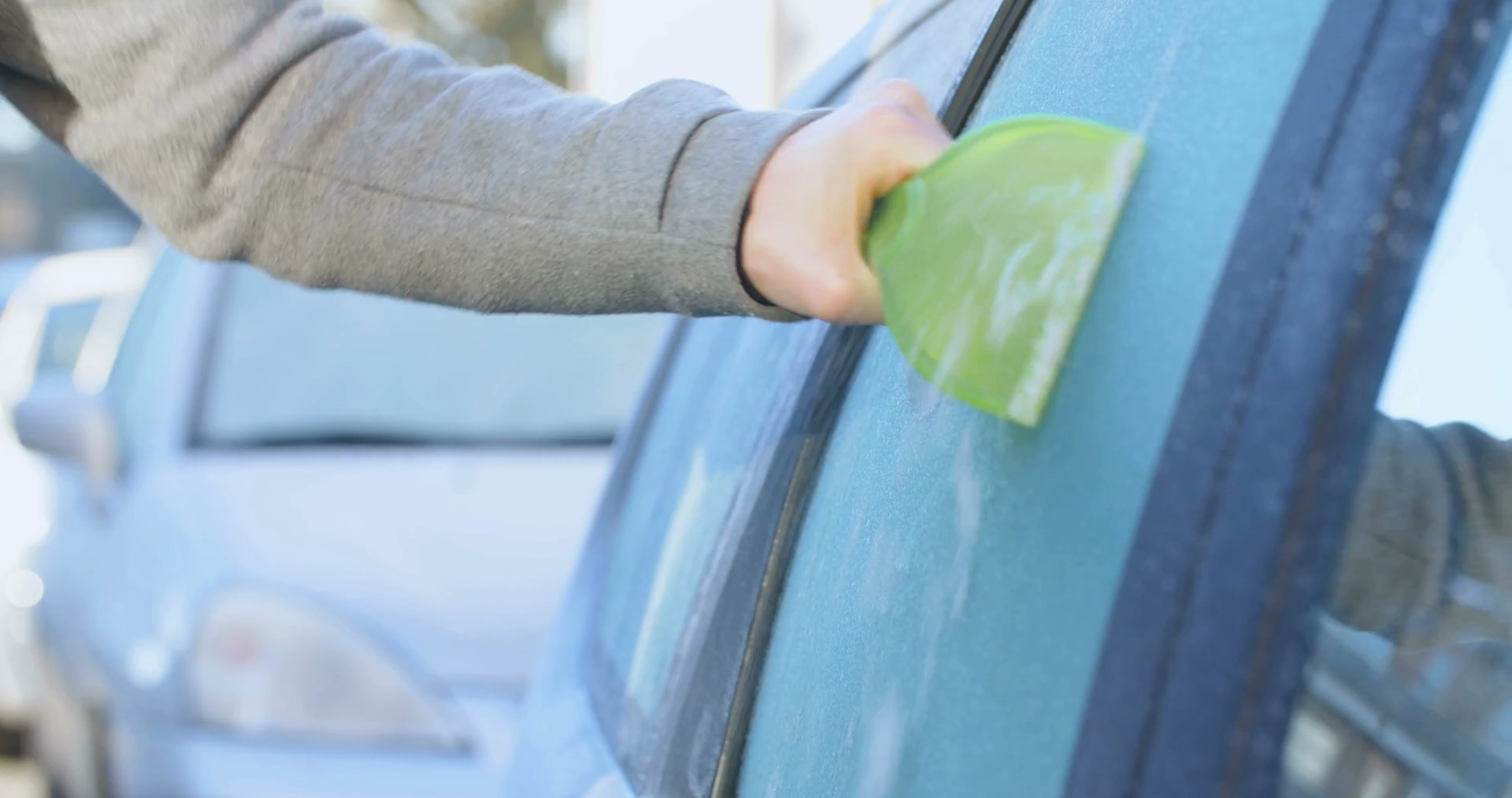 Woman Scraping Ice Off Window Of Parked Car Stock Footage SBV311739072