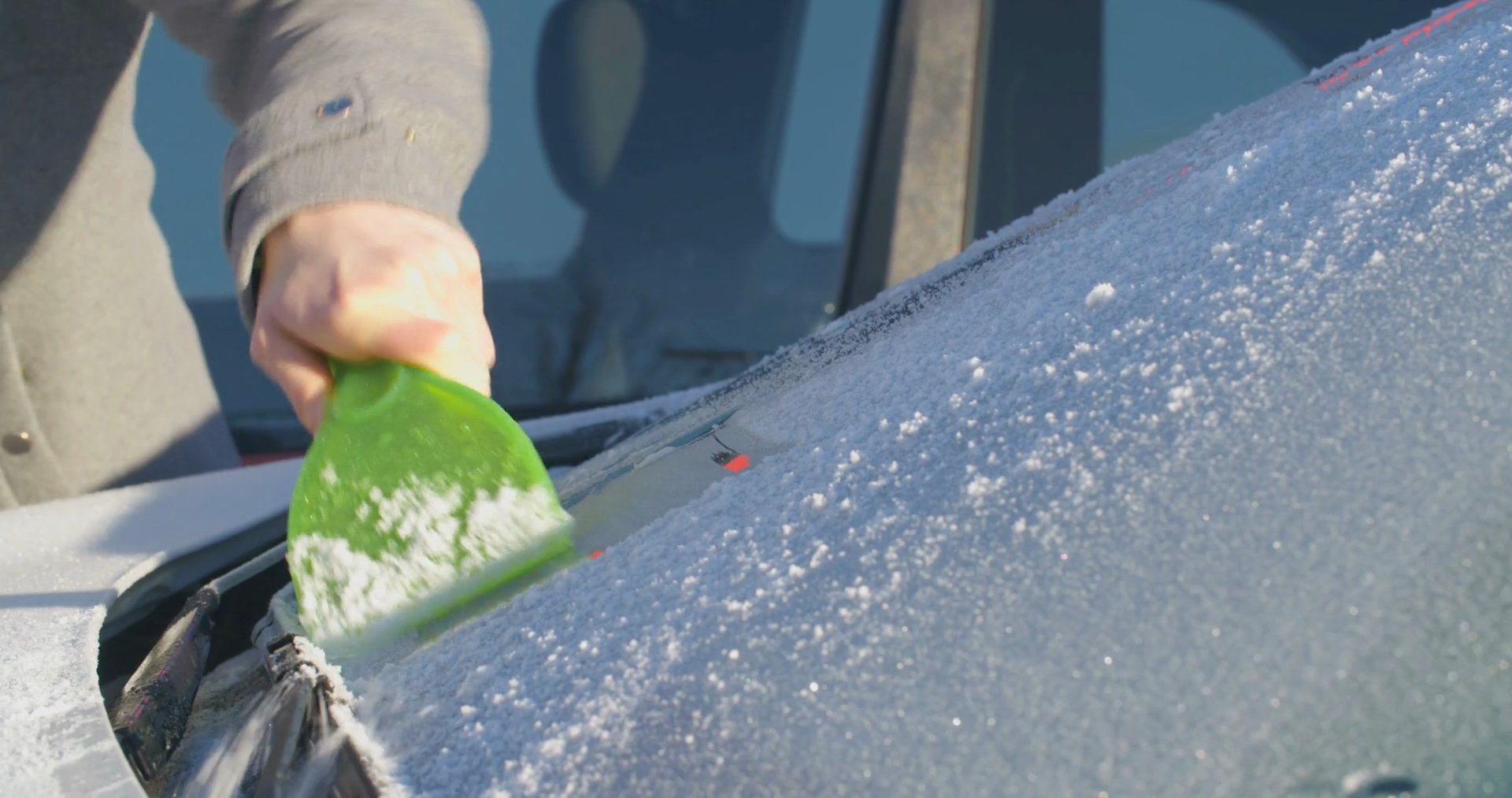 Woman Scraping Ice Off Windshield Of Parked Stock Footage SBV311739049