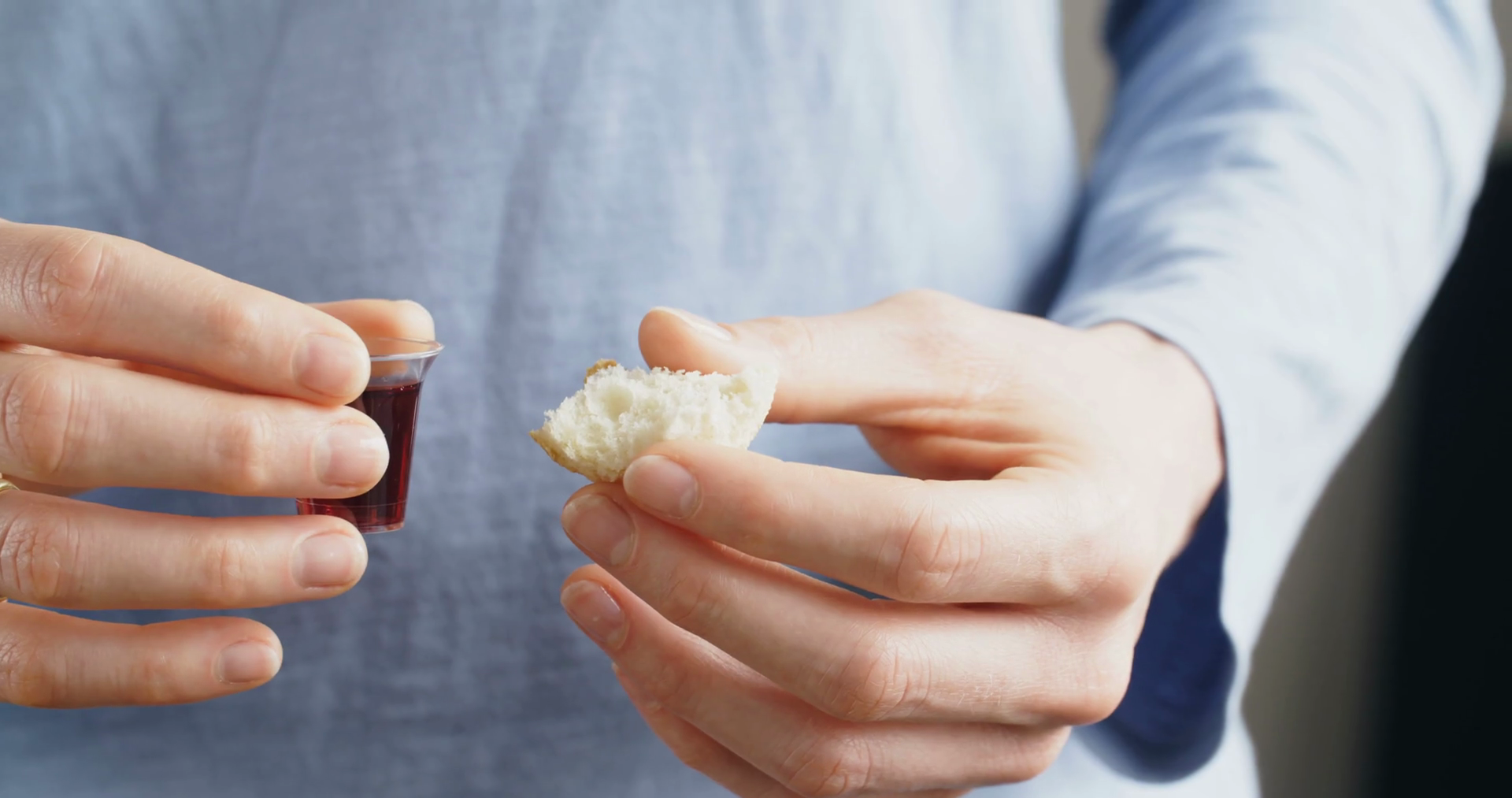 Young Christian woman holds bread and wine, the elements for Communion