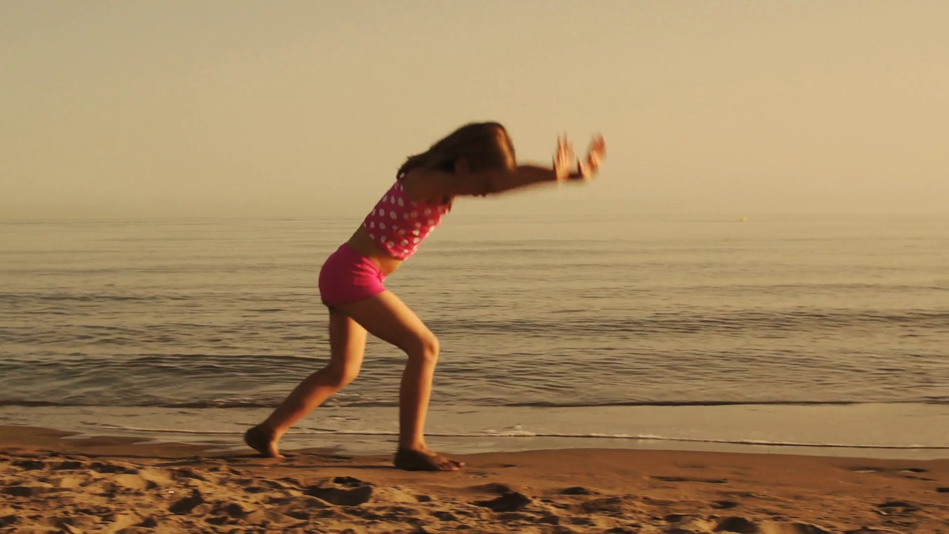 Slow Motion Of Girl Doing Cartwheels On Beach Stock Footage SBV