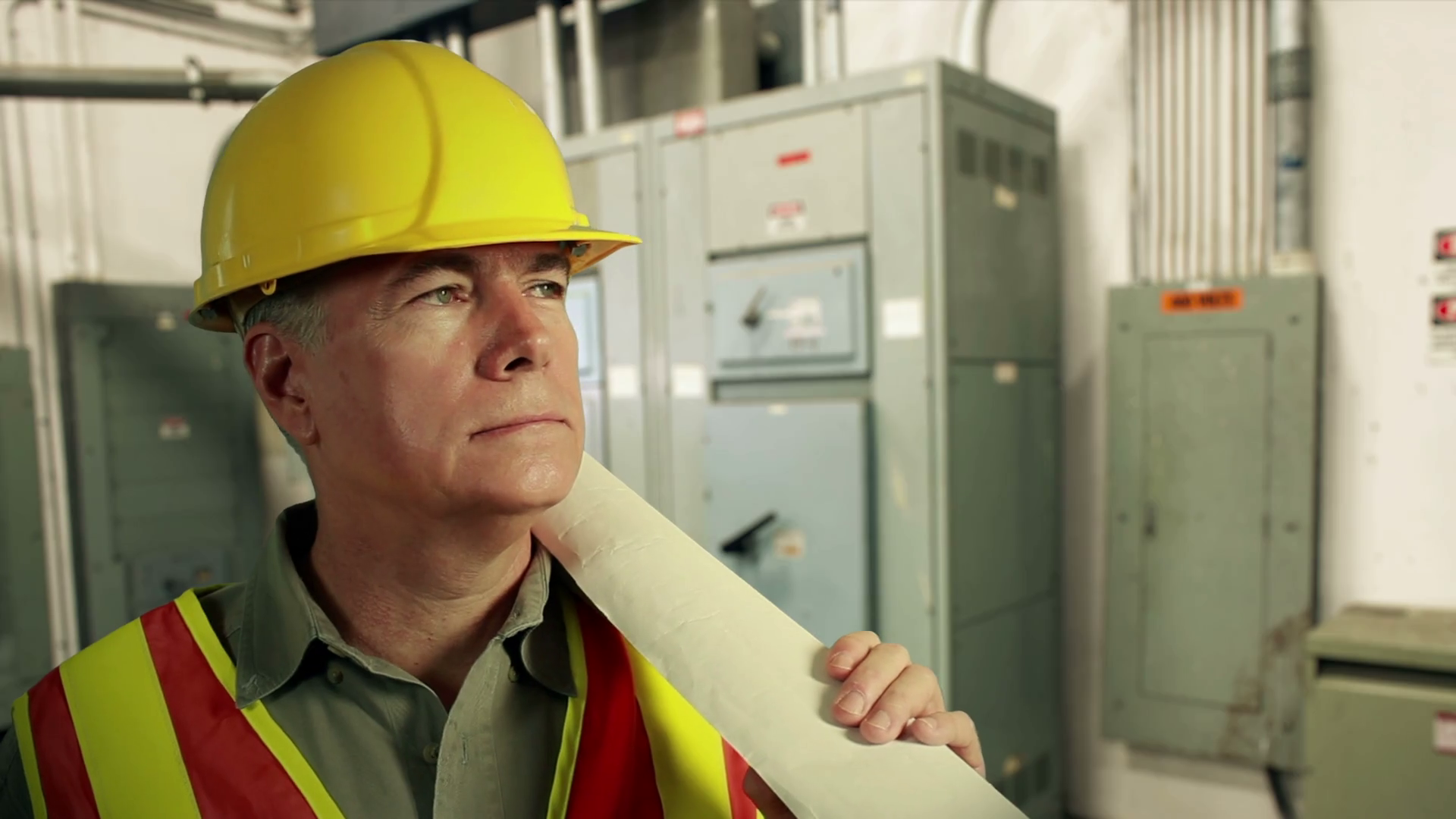 electrical engineer with plans smiles at camera Stock Video Footage