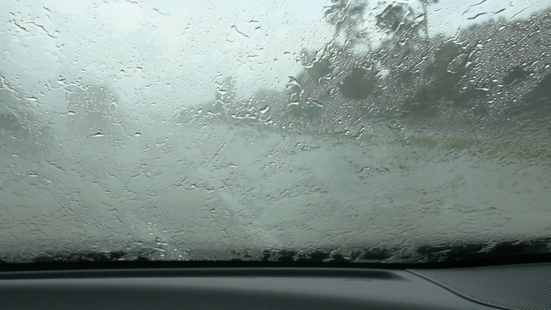 Slow motion windshield wipers driving in the rain. Stock Video Footage