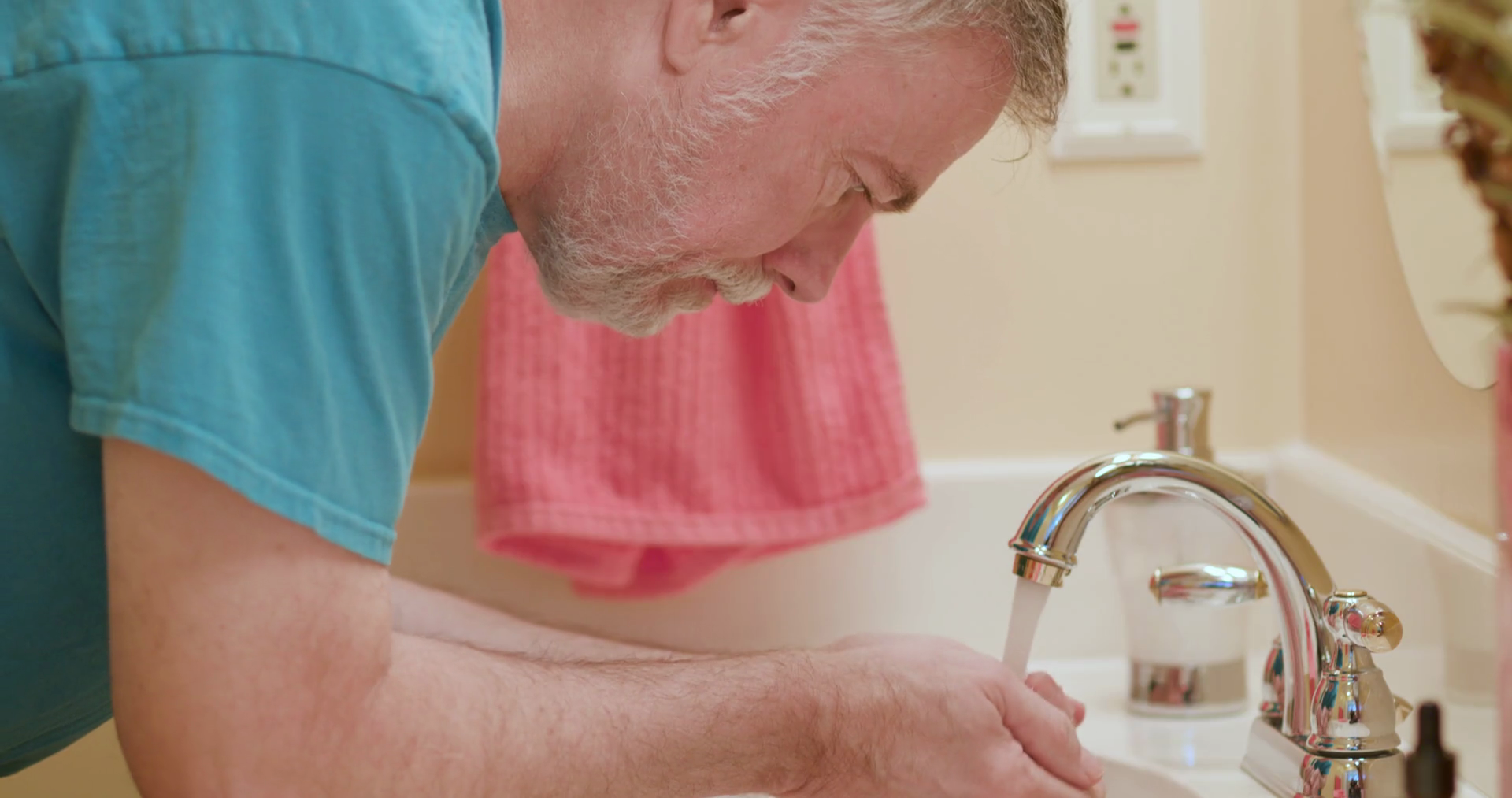 mature man washing his face in the bathroom sink Stock Video Footage 00