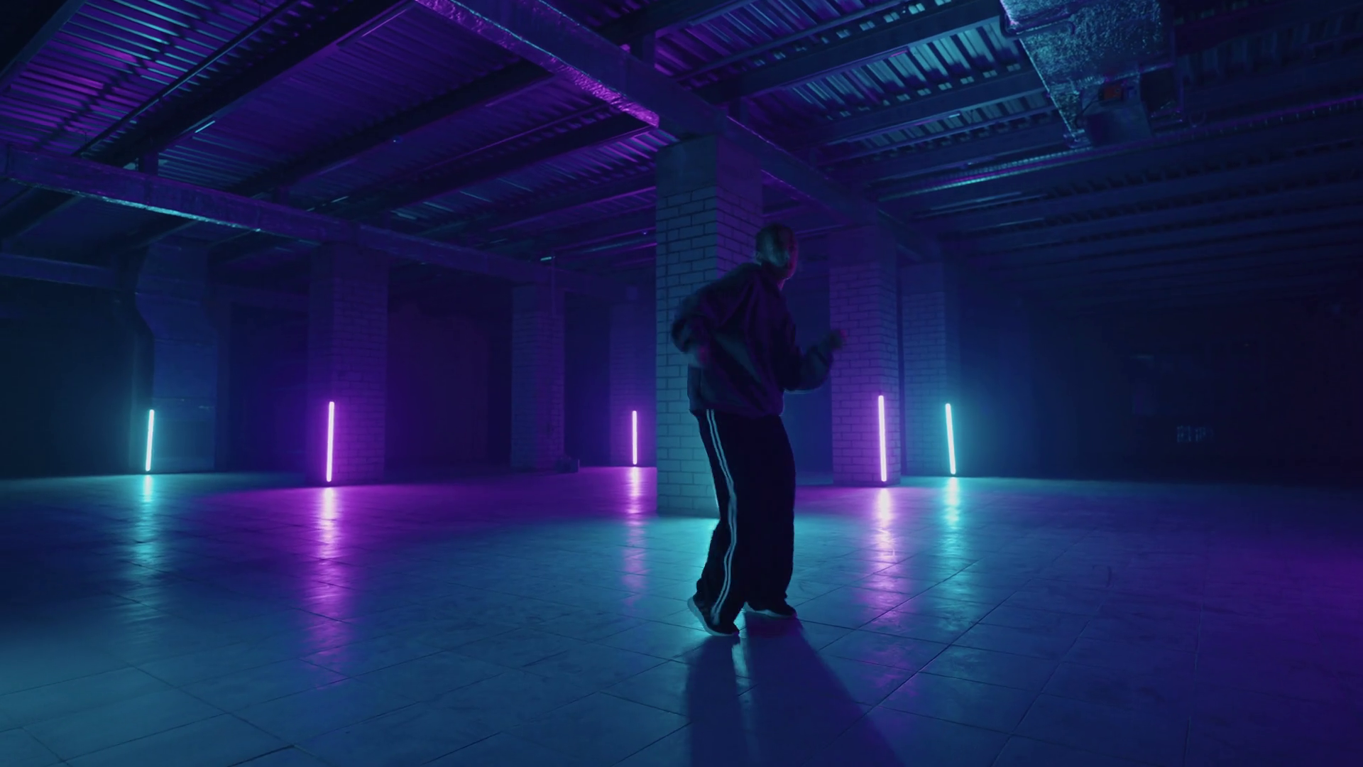 Stylish Female Dancer Moves to Music in a Smoky Room with Neon Lighting