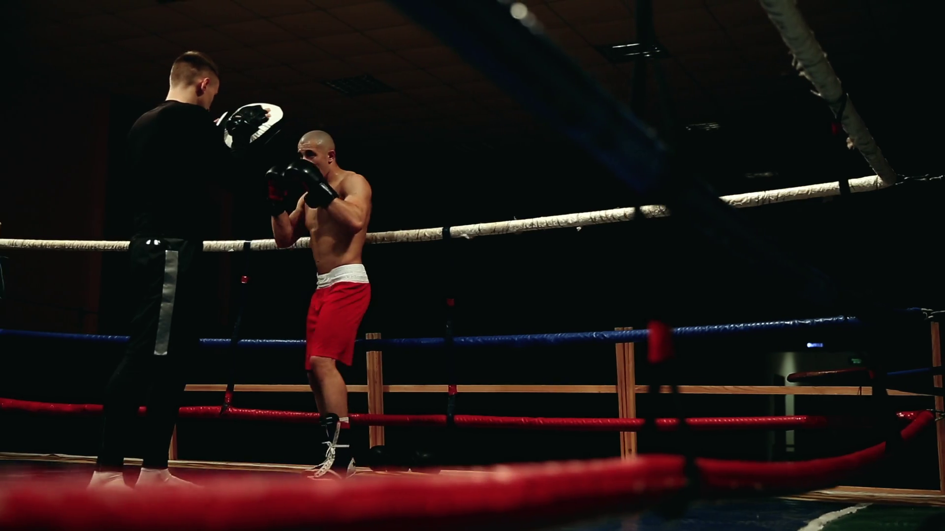 A Professional Boxer And His Coach Work On The Boxing Paws In The Ring Practicing A Series Of Punches Slider Stock Video Footage Storyblocks